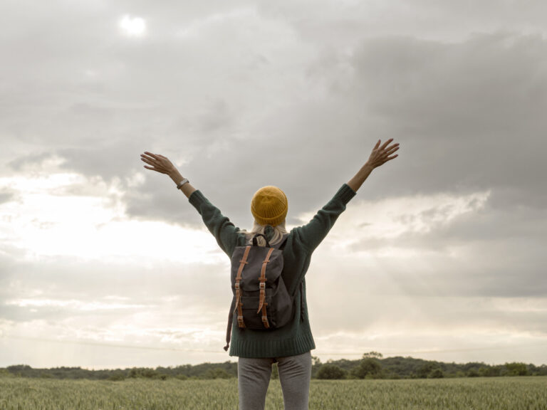 66bd83104702c_female-with-backpack-with-hands-raised